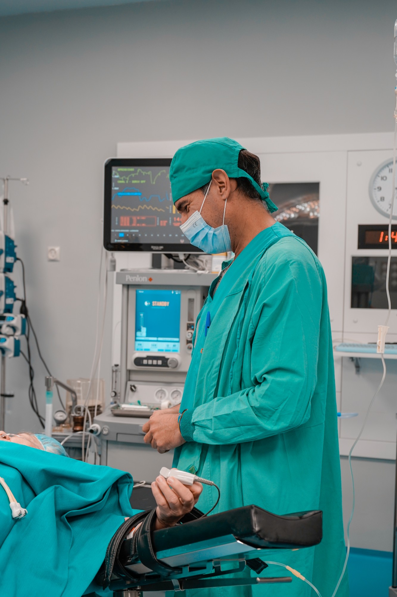 Anaesthetist monitoring a patient in the operating room
